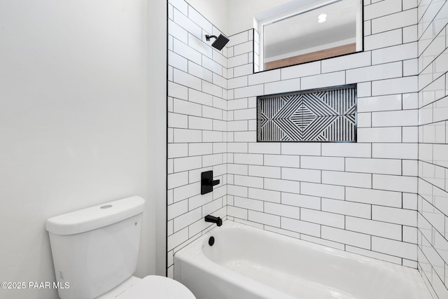 bathroom featuring toilet and tiled shower / bath combo