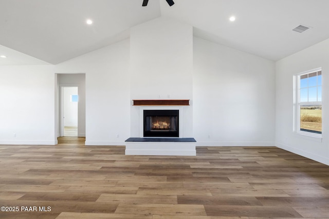 unfurnished living room featuring light hardwood / wood-style flooring, high vaulted ceiling, and ceiling fan