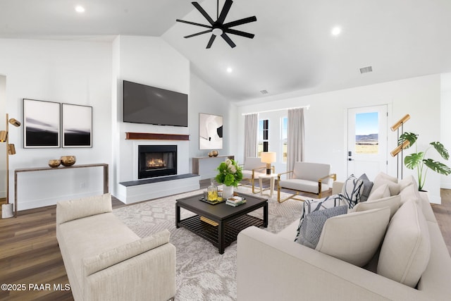 living room featuring hardwood / wood-style flooring, ceiling fan, and high vaulted ceiling