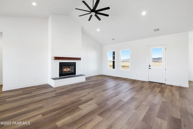 unfurnished living room featuring hardwood / wood-style flooring, high vaulted ceiling, and ceiling fan