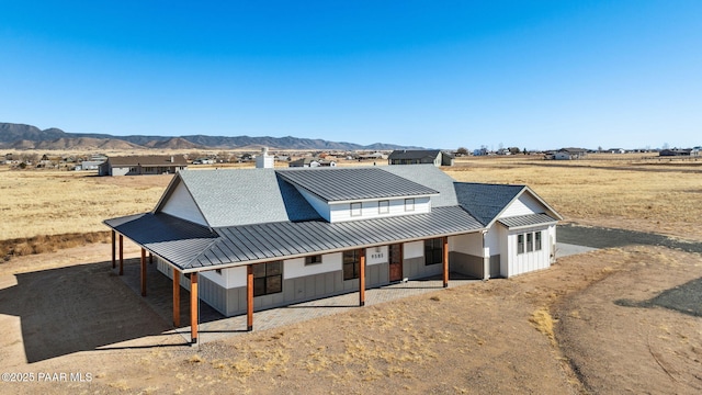 modern farmhouse style home with a mountain view