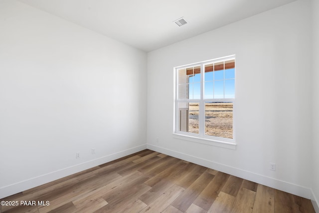 unfurnished room with light hardwood / wood-style floors