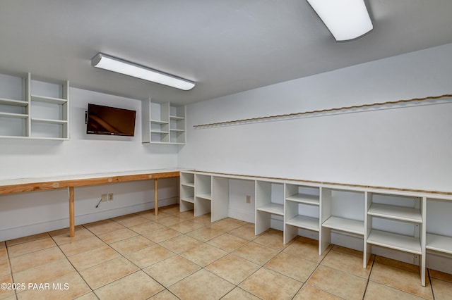 interior space featuring built in desk and light tile patterned floors