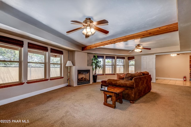 living room with light carpet, beam ceiling, a wealth of natural light, and ceiling fan