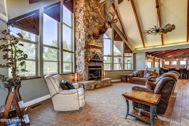 living room with a fireplace, high vaulted ceiling, beamed ceiling, and a healthy amount of sunlight