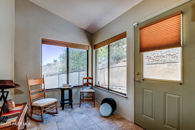 sunroom / solarium featuring vaulted ceiling