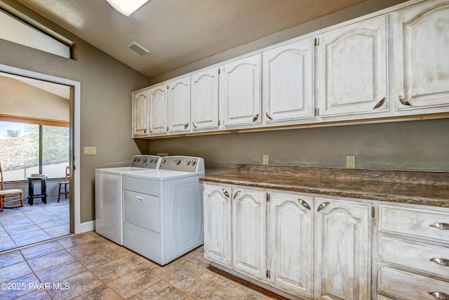 laundry room featuring cabinets and separate washer and dryer