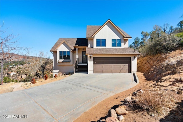 1310 W Carlock Dr, Prescott, AZ 86305 - view of front facade featuring stucco siding, concrete driveway, and an attached garage