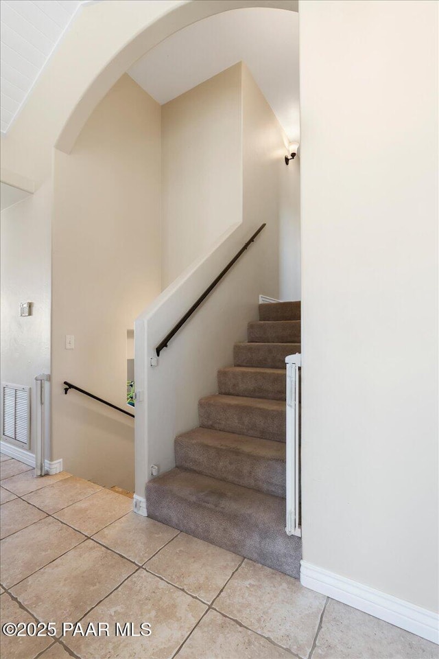 1310 W Carlock Dr, Prescott, AZ 86305 - stairway featuring arched walkways, tile patterned flooring, and baseboards