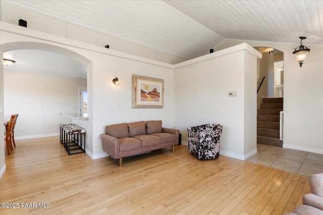 1310 W Carlock Dr, Prescott, AZ 86305 - living room with arched walkways, hardwood / wood-style flooring, lofted ceiling, wooden ceiling, and stairs