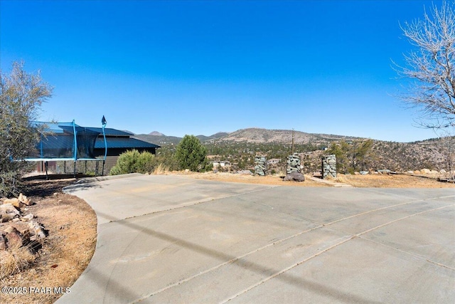 1310 W Carlock Dr, Prescott, AZ 86305 - view of patio / terrace with a mountain view and a trampoline