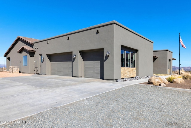 12300 W Slate Rd, Prescott, AZ 86305 - view of front of house featuring stucco siding, driveway, and an attached garage