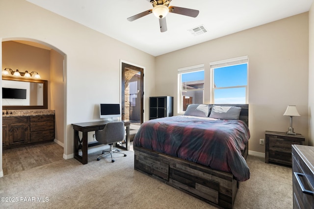 12300 W Slate Rd, Prescott, AZ 86305 - bedroom featuring visible vents, arched walkways, light colored carpet, and baseboards