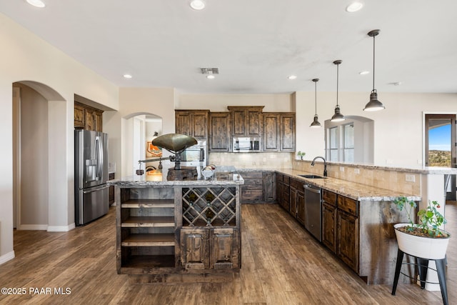 12300 W Slate Rd, Prescott, AZ 86305 - kitchen with visible vents, light stone counters, arched walkways, stainless steel appliances, and open shelves