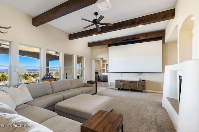 12300 W Slate Rd, Prescott, AZ 86305 - carpeted cinema featuring beamed ceiling, visible vents, a ceiling fan, a fireplace, and baseboards