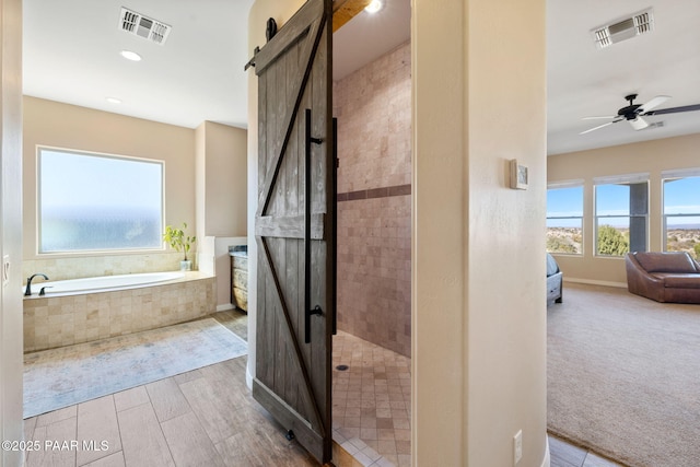 12300 W Slate Rd, Prescott, AZ 86305 - bathroom with visible vents, connected bathroom, a stall shower, and ceiling fan