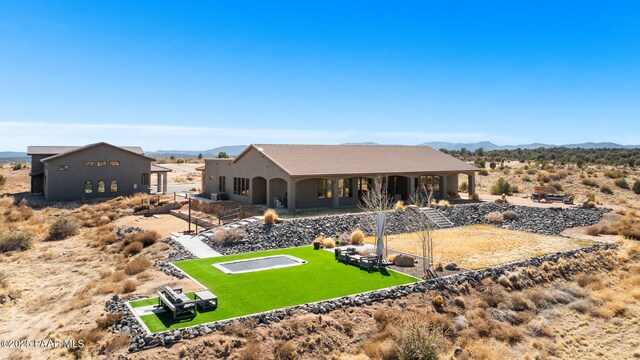 12300 W Slate Rd, Prescott, AZ 86305 - back of property featuring a yard, stucco siding, a mountain view, and a tiled roof