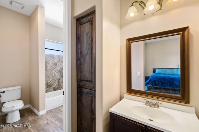 12300 W Slate Rd, Prescott, AZ 86305 - ensuite bathroom featuring vanity, wood finished floors, visible vents, baseboards, and toilet