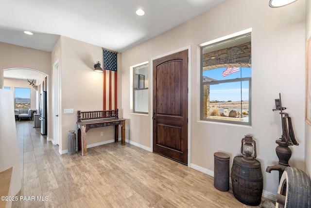 12300 W Slate Rd, Prescott, AZ 86305 - foyer featuring recessed lighting, light wood-style floors, arched walkways, and baseboards