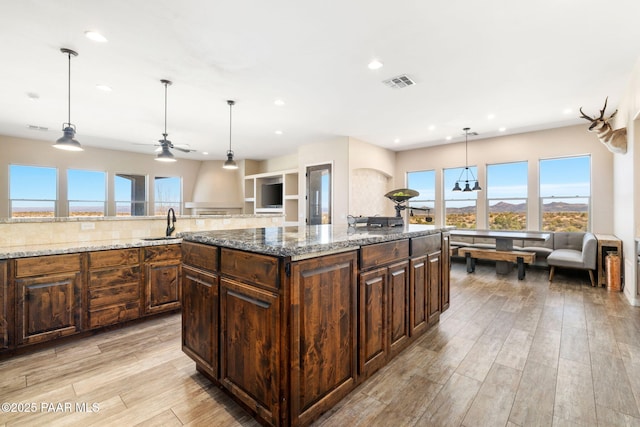 12300 W Slate Rd, Prescott, AZ 86305 - kitchen with visible vents, light stone counters, recessed lighting, light wood-style floors, and ceiling fan