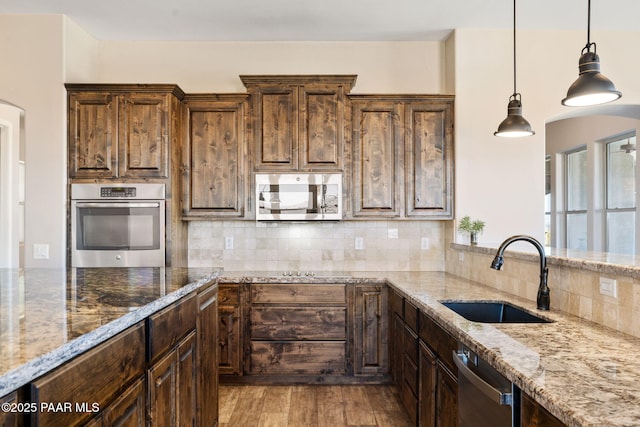 12300 W Slate Rd, Prescott, AZ 86305 - kitchen with decorative backsplash, appliances with stainless steel finishes, wood finished floors, and a sink