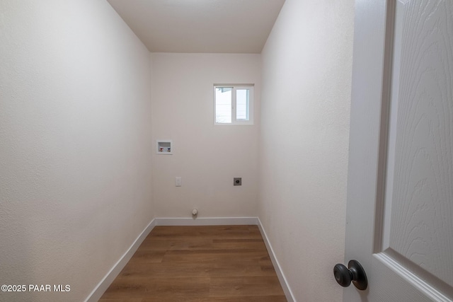 laundry area featuring baseboards, washer hookup, laundry area, wood finished floors, and hookup for an electric dryer