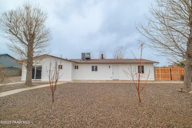 rear view of property with a patio, central AC, and fence