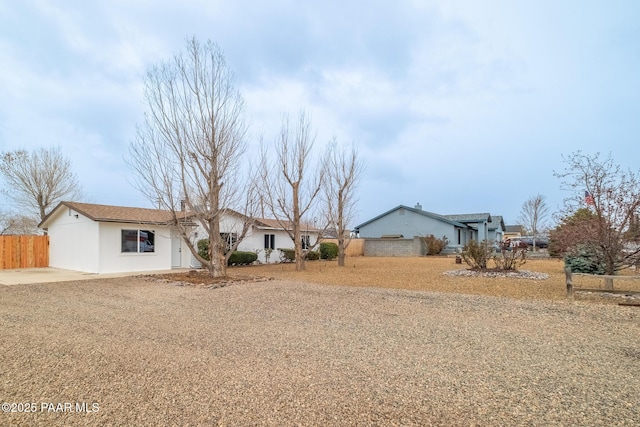 ranch-style home with fence