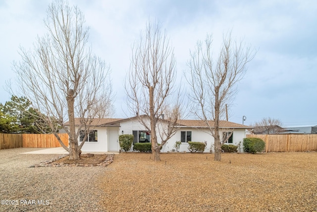 ranch-style house with stucco siding and fence