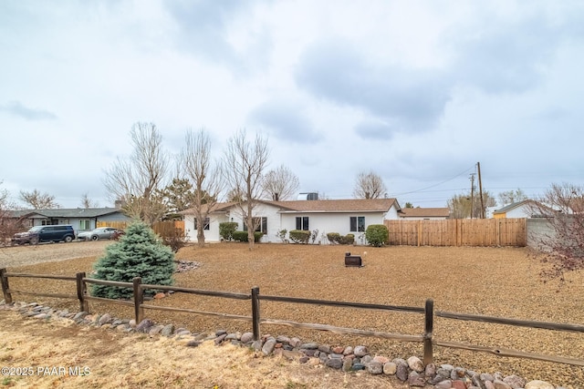 ranch-style home with fence