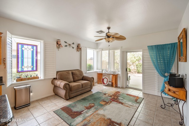 living room with ceiling fan and light tile patterned floors