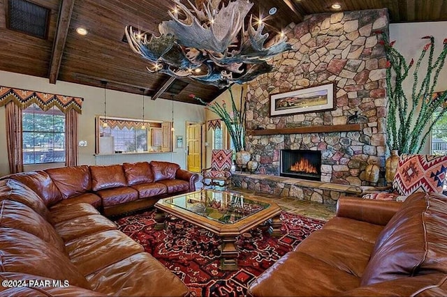 living room with vaulted ceiling with beams, a stone fireplace, and wooden ceiling