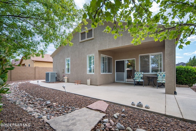 rear view of property featuring central air condition unit and a patio