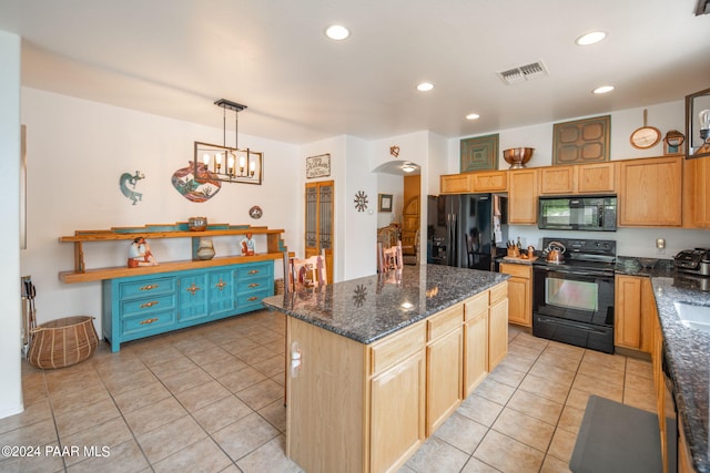 kitchen with a center island, light tile patterned flooring, black appliances, and decorative light fixtures