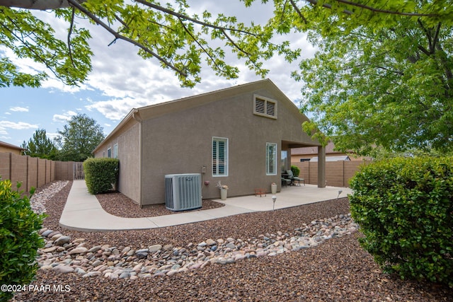 rear view of house featuring a patio area and central AC unit