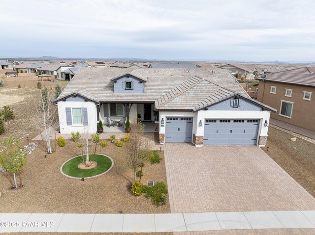 5306 Rocky Vista Dr, Prescott, AZ 86301 - view of front of house with an attached garage, decorative driveway, a residential view, and a porch