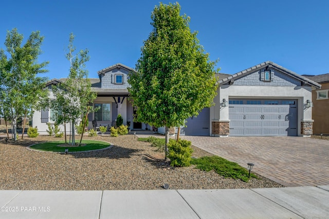 5306 Rocky Vista Dr, Prescott, AZ 86301 - view of property hidden behind natural elements featuring a garage, decorative driveway, stucco siding, and stone siding