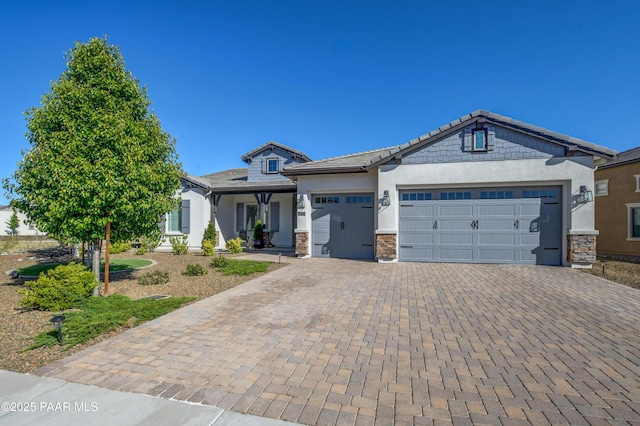 5306 Rocky Vista Dr, Prescott, AZ 86301 - view of front of house featuring decorative driveway, an attached garage, stone siding, and stucco siding