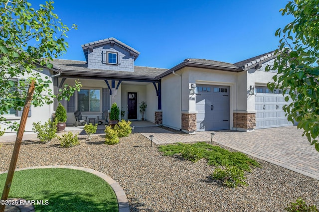 5306 Rocky Vista Dr, Prescott, AZ 86301 - view of front of house with a garage, covered porch, stucco siding, decorative driveway, and stone siding
