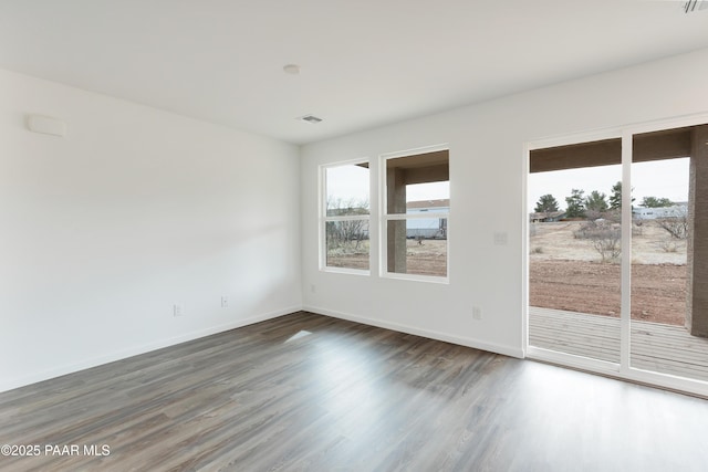 empty room featuring dark hardwood / wood-style flooring