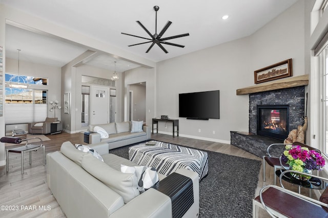 3771 Blazing Ore Trl, Prescott, AZ 86301 - living room with ceiling fan with notable chandelier, light wood-type flooring, and a premium fireplace