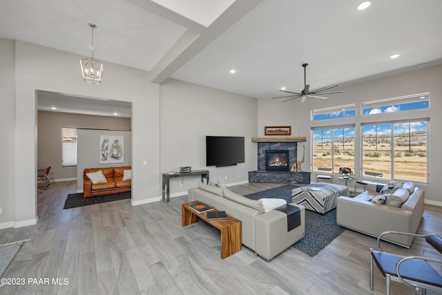 3771 Blazing Ore Trl, Prescott, AZ 86301 - living room featuring a chandelier, recessed lighting, a stone fireplace, light wood finished floors, and a ceiling fan