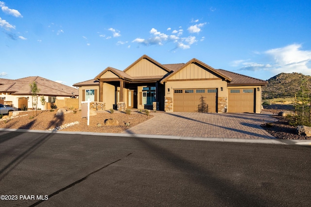 3771 Blazing Ore Trl, Prescott, AZ 86301 - view of front facade featuring an attached garage, stone siding, driveway, and board and batten siding