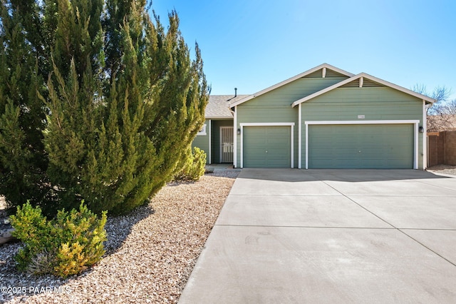 view of front of property featuring a garage and concrete driveway