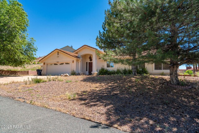 1269 N Oxbow Dr, Dewey-Humboldt, AZ 86327 - view of front facade with stucco siding, an attached garage, and driveway