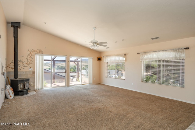 1269 N Oxbow Dr, Dewey-Humboldt, AZ 86327 - unfurnished living room featuring vaulted ceiling, a wood stove, ceiling fan, and carpet flooring