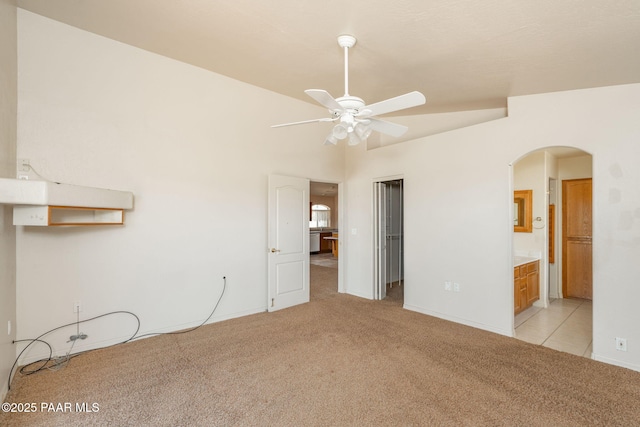 1269 N Oxbow Dr, Dewey-Humboldt, AZ 86327 - unfurnished bedroom with light carpet, arched walkways, a closet, and connected bathroom