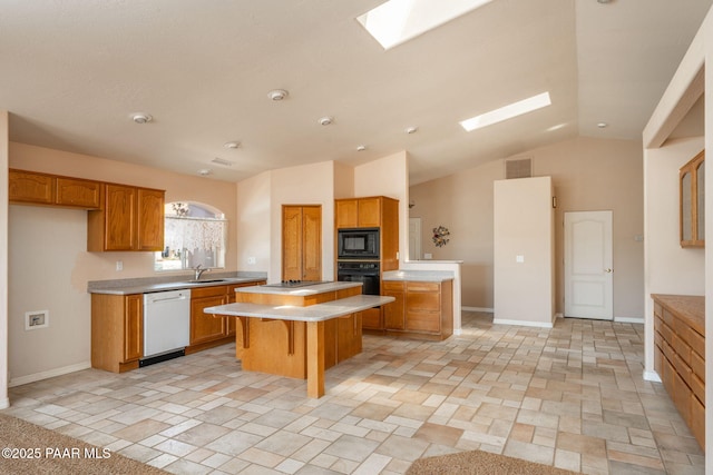 1269 N Oxbow Dr, Dewey-Humboldt, AZ 86327 - kitchen featuring black appliances, light countertops, a center island, a skylight, and vaulted ceiling