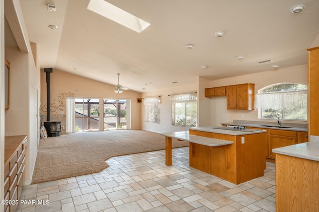 1269 N Oxbow Dr, Dewey-Humboldt, AZ 86327 - kitchen featuring open floor plan, light colored carpet, a kitchen island, plenty of natural light, and lofted ceiling