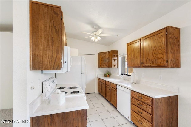 kitchen with a sink, white appliances, brown cabinetry, a ceiling fan, and light countertops